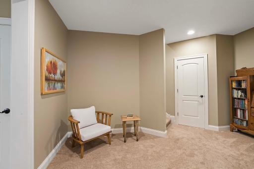 Discover endless possibilities in this inviting basement landing, offering flexibility to serve as a cozy sitting room or a convenient walk-through space.