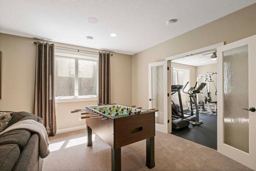 Bathe in natural light streaming in through the large egress window, illuminating the space and creating a bright and inviting ambiance. Set up your favorite game table and indulge in friendly competition and leisurely play.