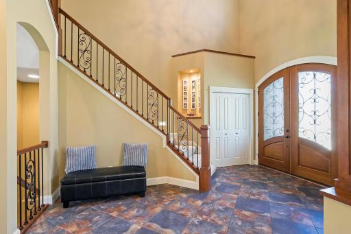 Welcome to a home where every detail exudes sophistication and style. As you step through the gorgeous double wood doors, you're greeted by a breathtaking 2-story foyer that sets the tone for the entire residence.