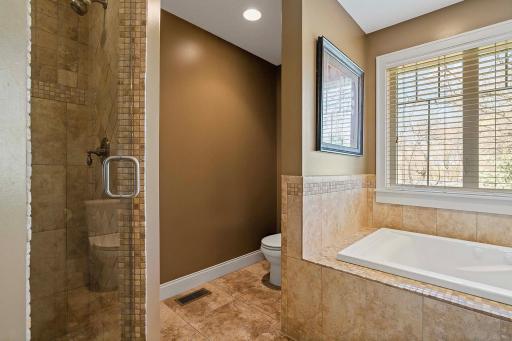 Enclosed by a sleek glass door, step into the tiled shower and experience the ultimate in comfort and style. Enjoy added privacy and convenience with a separate toilet area, discreetly tucked away.