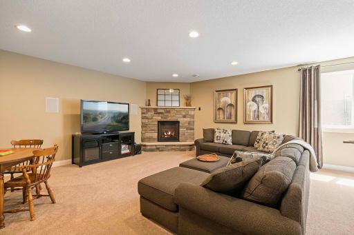 Spread out and relax in the generous layout of the basement recreation room, offering plenty of room to accommodate various activities and entertainment options and boasting a cozy gas fireplace for both ambiance and warmth.