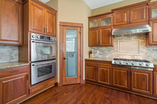 A true chef's delight, the walk-in pantry provides additional storage space & convenience for stocking up on kitchen supplies. Equipped with high-end stainless steel appliances, including a gas cooktop, this kitchen combines style with performance.