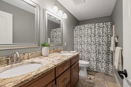 Check out this upstairs full bathroom, offering a full tub and shower, granite countertops, and a double vanity. Neutral paint allows you to customize accessories to your liking.