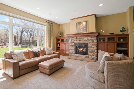Boasting a large window overlooking the backyard, plush carpeting, and a charming gas fireplace, this family room offers the perfect retreat for cozy evenings with loved ones and quiet moments of relaxation.