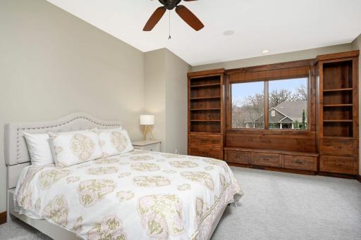 Bedroom #3 features built-in bookshelves, storage, and window seat.