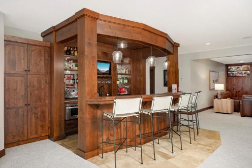 Wet bar features wine fridges, a microwave, and an ice maker.
