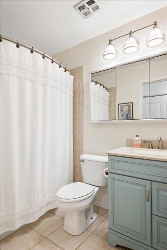 The upper level full bath has tile flooring, tile tub surround and an updated vanity.