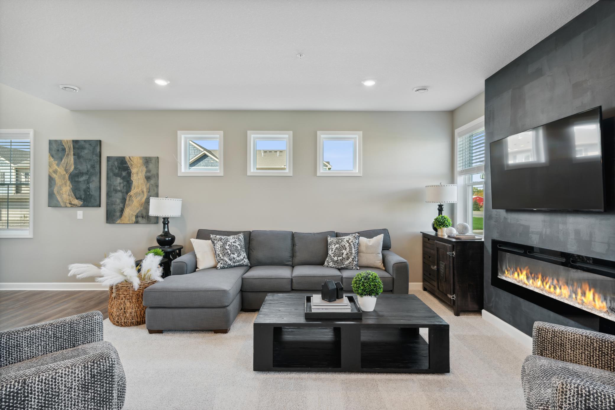*Photos of model home; colors and finishes will vary. The lovely living room features large windows with plenty of natural light and an electric fireplace!