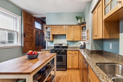 The updated kitchen has plenty of storage and countertop space (island can stay with the home).