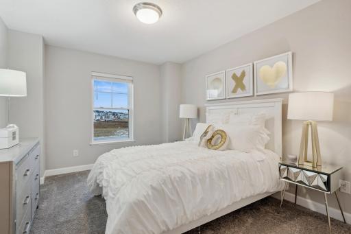 (Photo of a decorated model, actual homes finishes will vary) One of two secondary bedrooms.