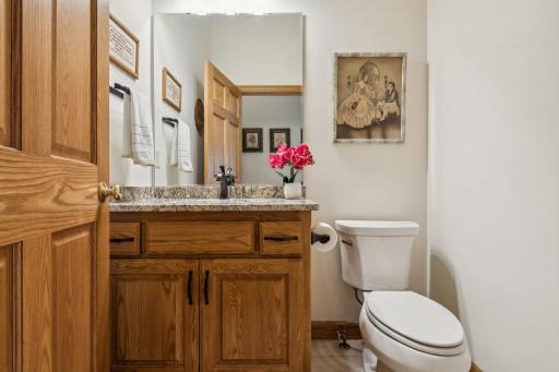This is the main level powder room! This bathroom features ceramic tile flooring, Kohler toilet and undermount sink, solid oak tall vanity, door and millwork, granite countertop, and oil-rubbed bronze fixtures and pulls.