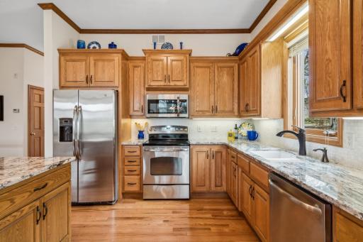 The solid oak cabinetry is beautiful, and include these features: 42" uppers, double stack Lazy Susan, crown molding, bread board, under cabinet lighting, custom roll-outs & pantry cabinet.