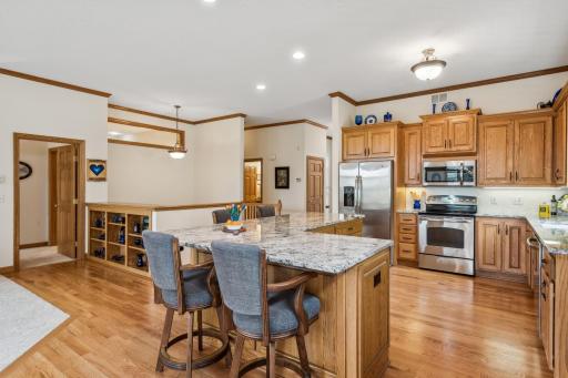 Please note the professionally painted, neutral walls, semi-flush-mount light, and three recessed lights above the island.