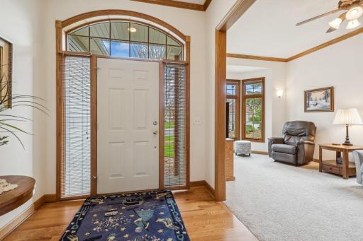 Welcome! Quite the entry here! Please notice the beautiful solid oak hardwood flooring, millwork & crown molding! The sidelights & transom add to the brightness!