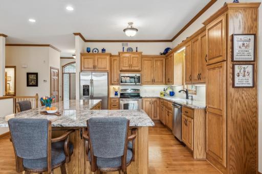 This kitchen also features the following stainless steel appliances: GE side by side fridge with ice and water, built-in Frigidaire microwave, GE 5-burner electric range, and GE built-in dishwasher with stainless steel interior.