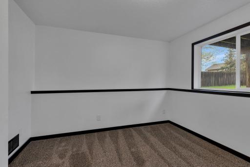 Second lower level bedroom is neutral and waiting for you to make your own. Perfect for a guest bedroom, at home gym, office and so much more!