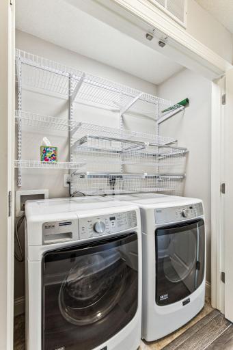 Full size washer and dryer with custom shelving.