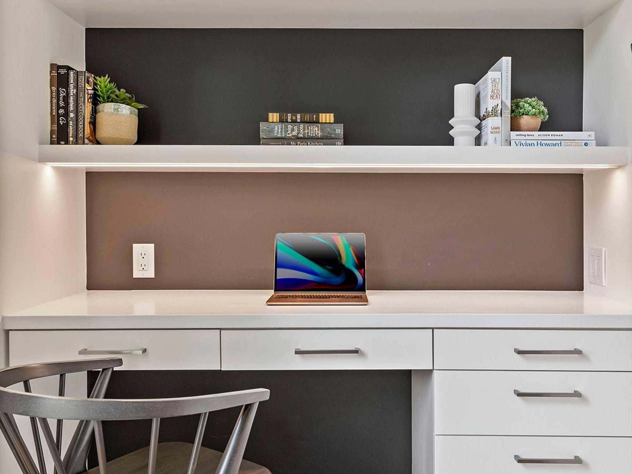 A convenient command center mirrors the pantry, providing the perfect space for a home office. Floor-to-ceiling windows in both rooms bathe these efficient spaces with natural light throughout the day.