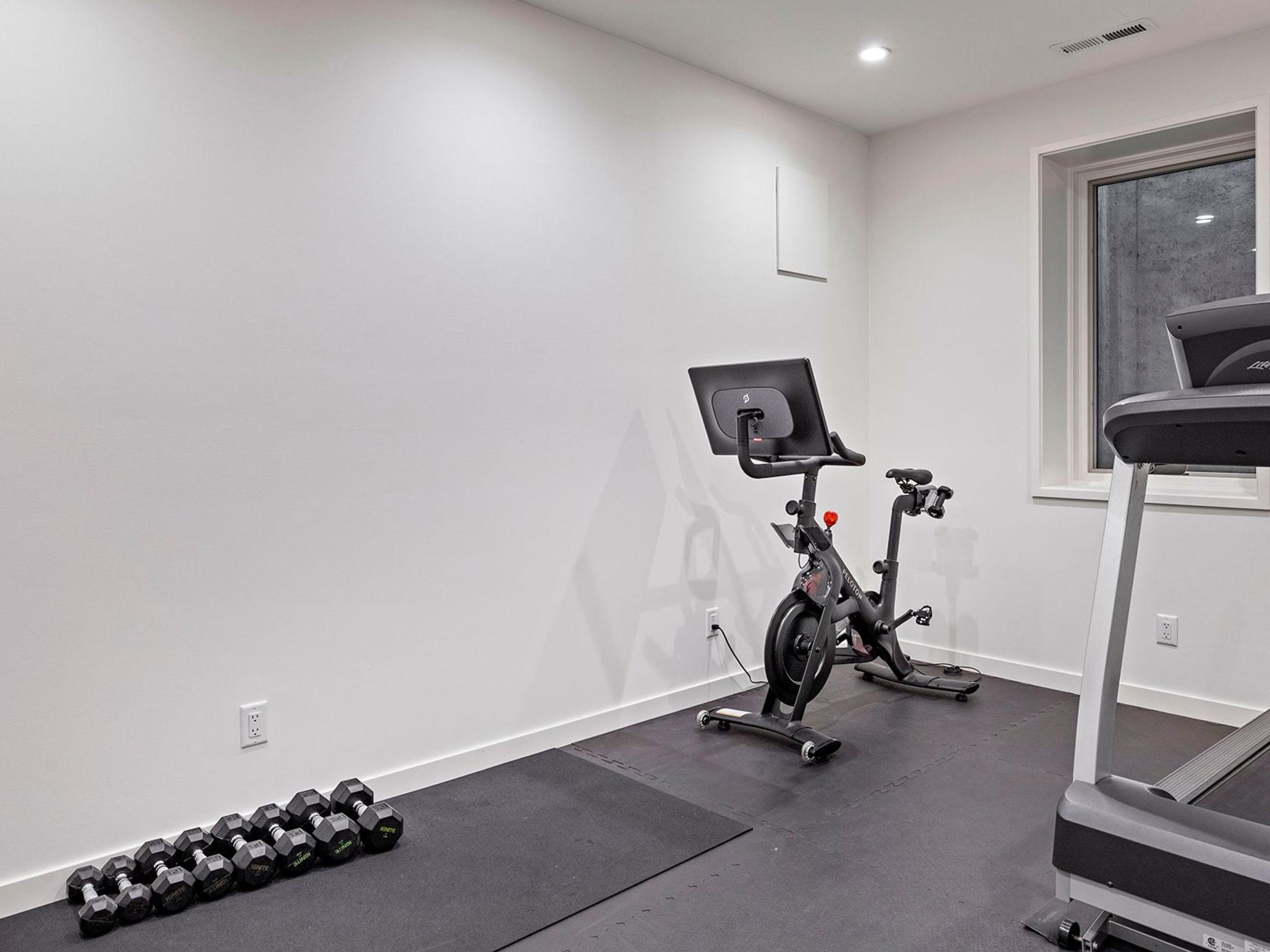 Lower level fitness room with egress window for added light.