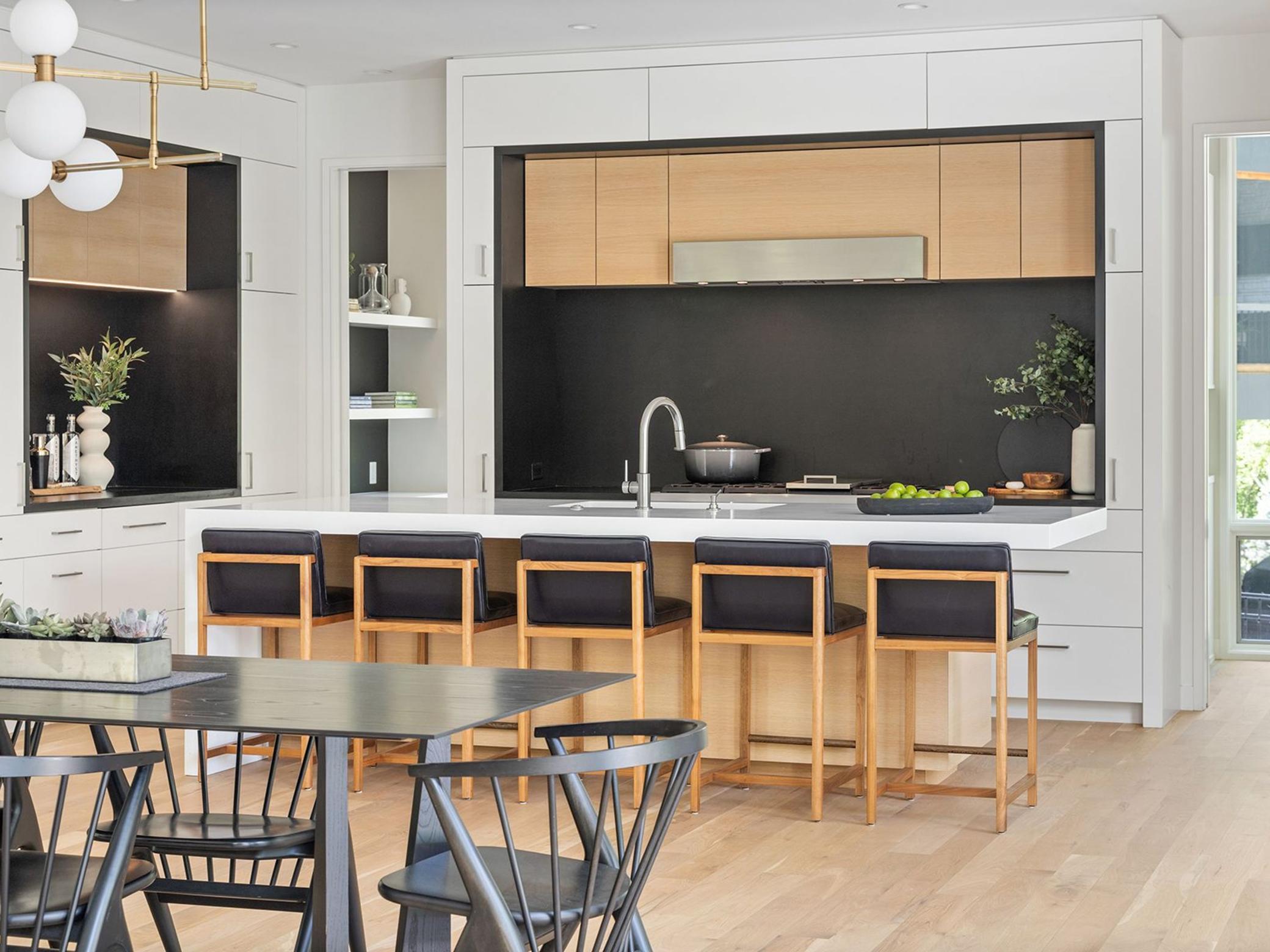 The custom kitchen features stunning and sustainable Richlite countertop surfaces, custom cabinetry and top-of-the-line appliances.