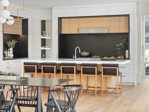 The custom kitchen features stunning and sustainable Richlite countertop surfaces, custom cabinetry and top-of-the-line appliances.