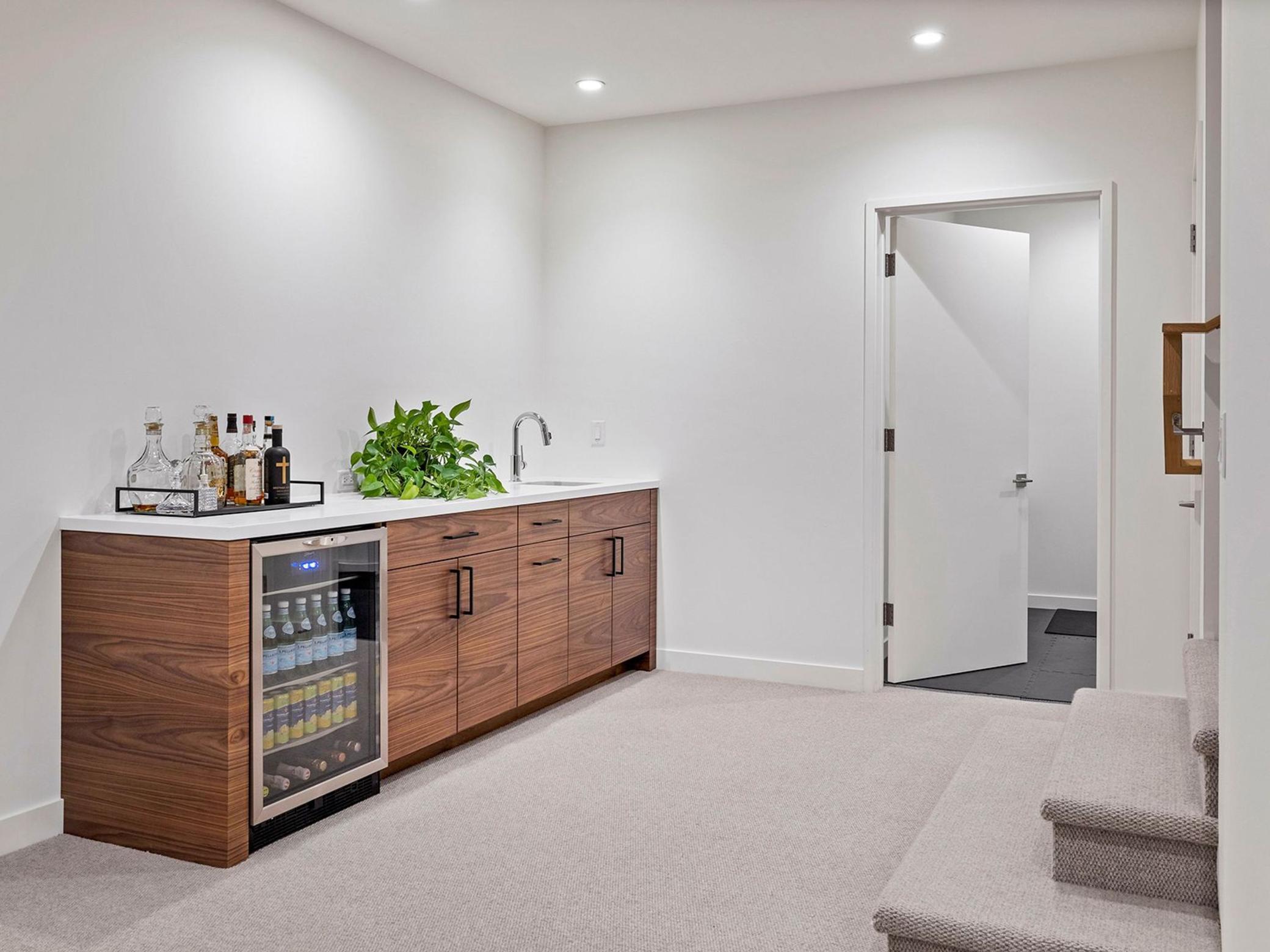 Lower level wet bar, with a view to the fitness room.