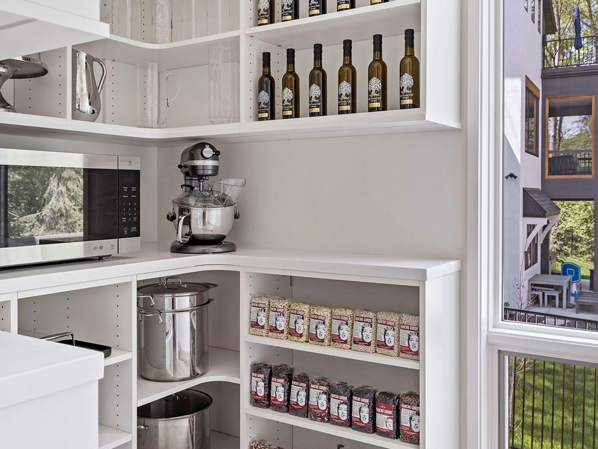 Behind the kitchen, you'll find a large walk-in pantry with floor-to-ceiling windows.