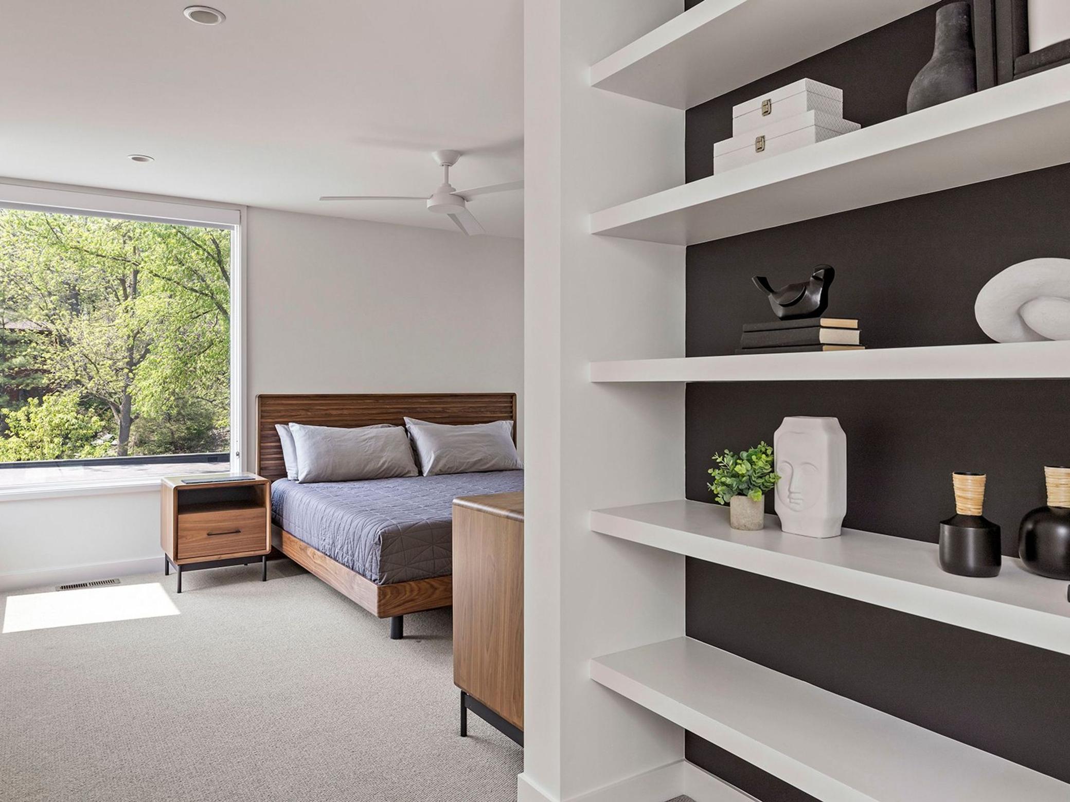 The upper-level guest suite, complete with an ensuite bathroom, is bathed in extraordinary natural light, creating an inviting and serene atmosphere.