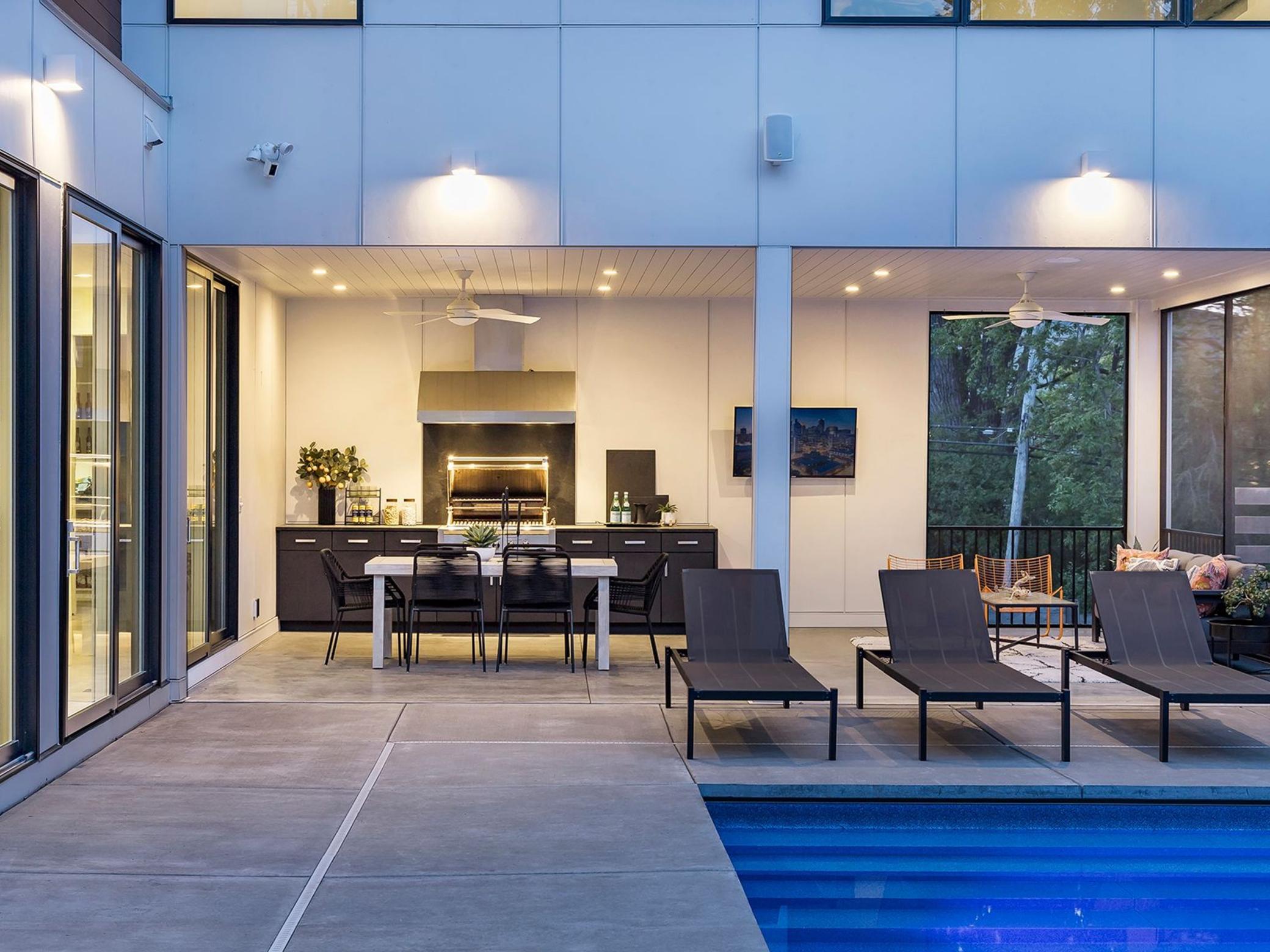 Stunning outdoor kitchen with built-in gas grill and restaurant-grade vent hood.