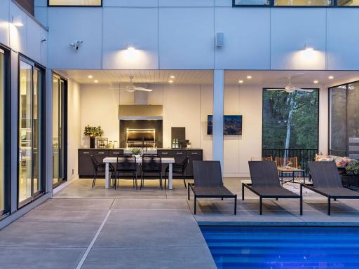 Stunning outdoor kitchen with built-in gas grill and restaurant-grade vent hood.
