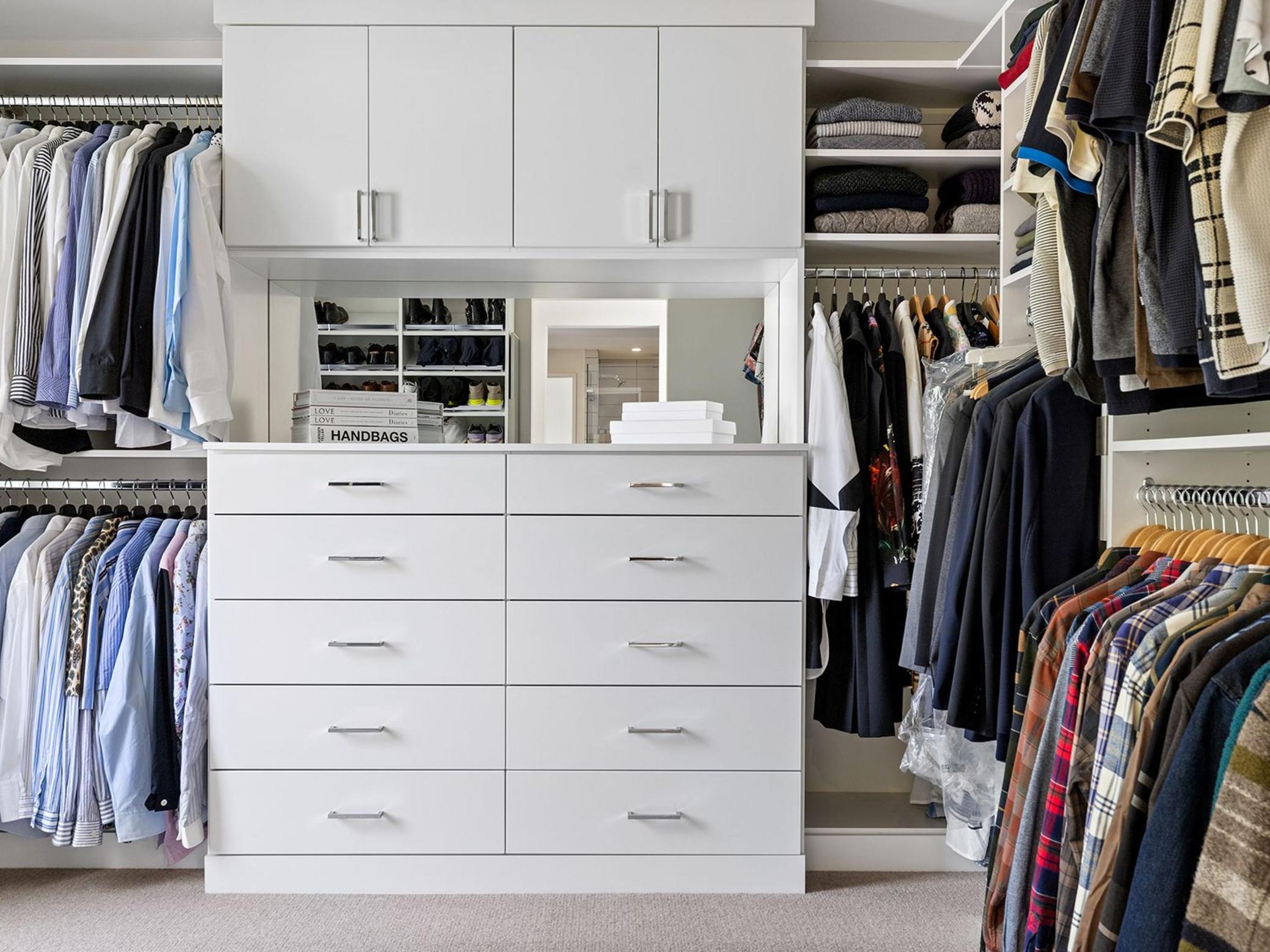 The primary bedroom features an expansive, elegantly designed walk-in closet, offering ample storage space with sophisticated finishes and bespoke organizational systems.