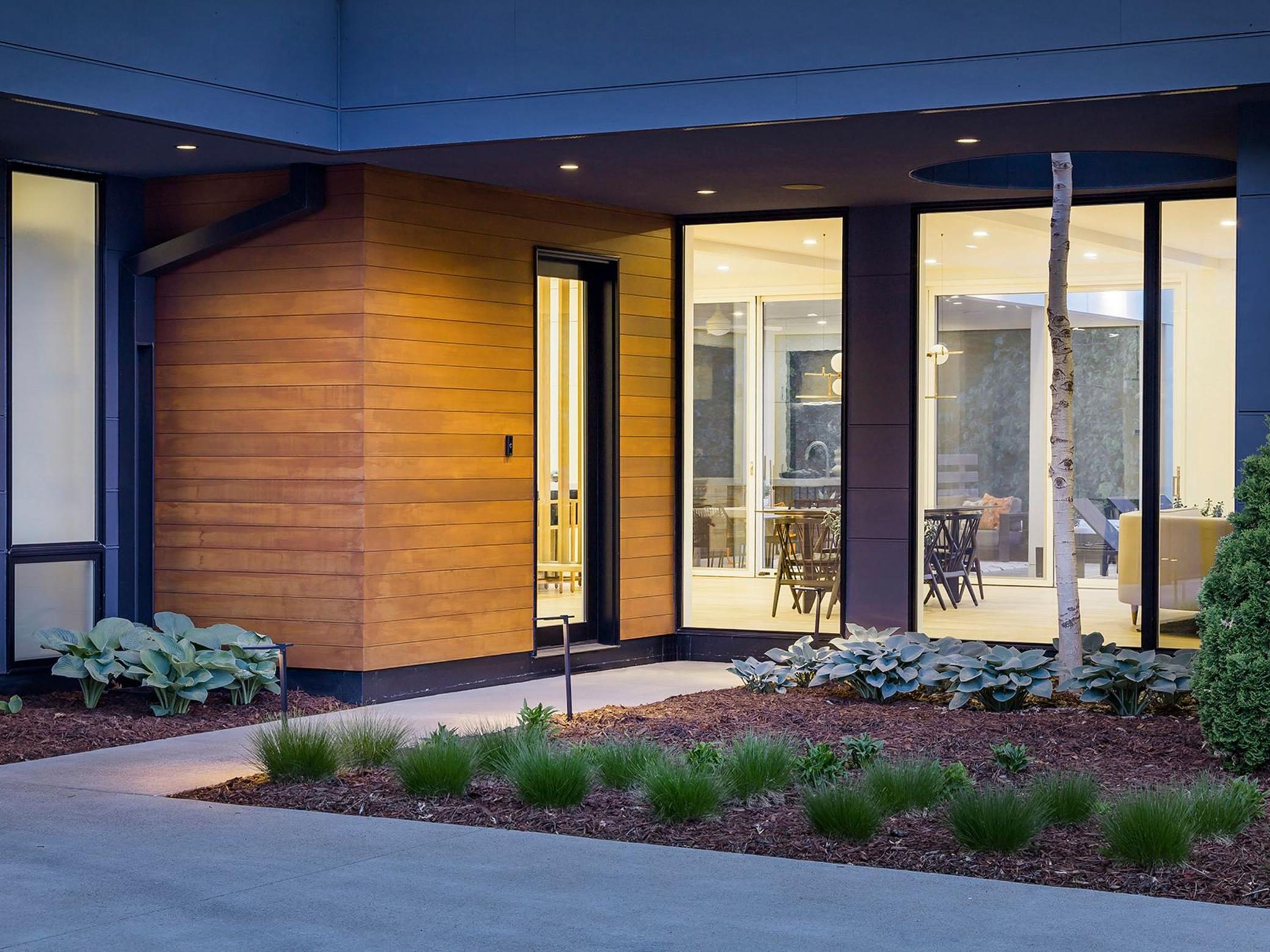 The expertly designed exterior lighting and thoughtful landscaping invite you in.