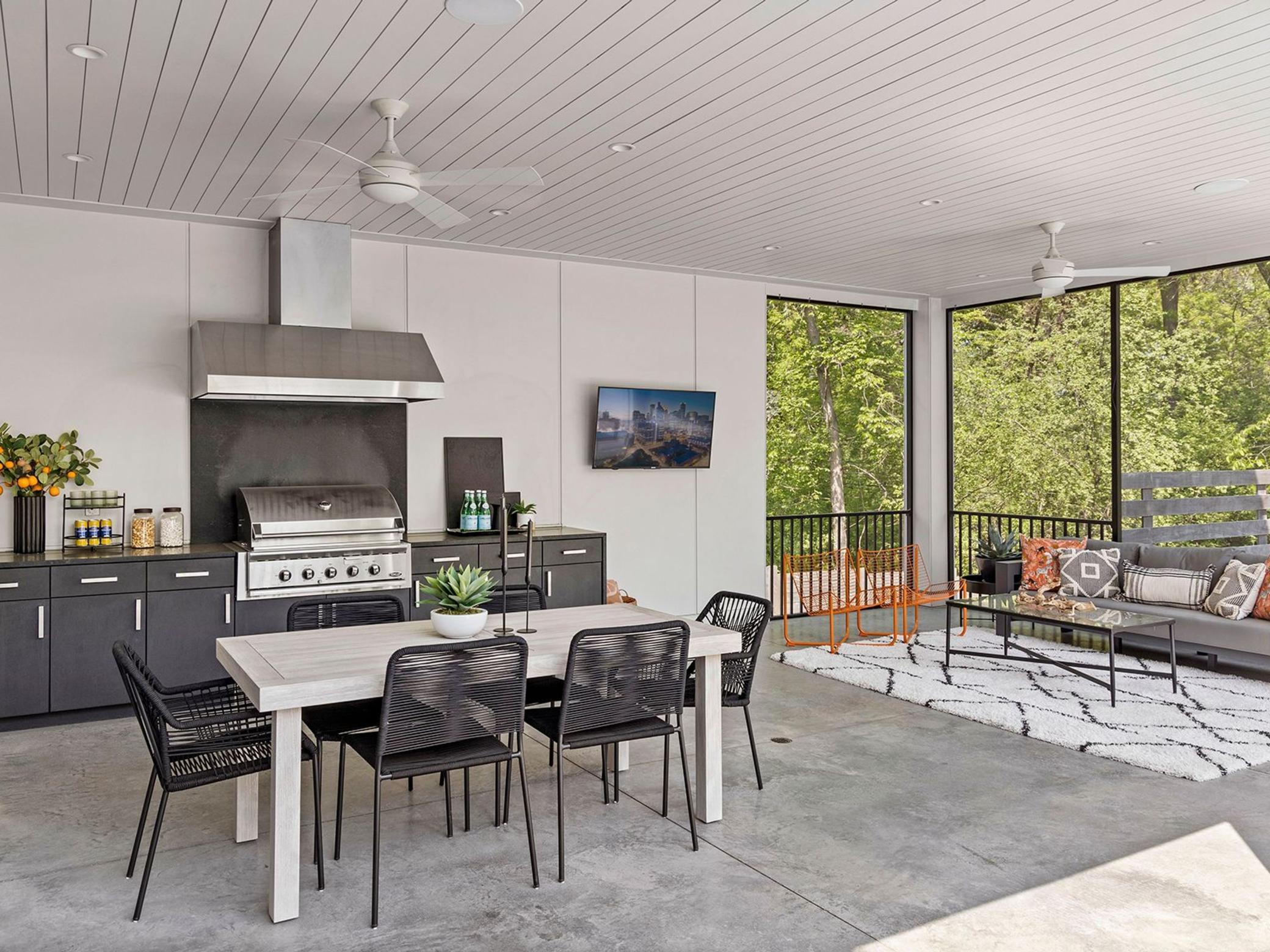 Double fans offer refreshing breezes during the warmer months. This porch is equipped with a sound system and lounge area, perfect for movie nights or enjoying the big game.