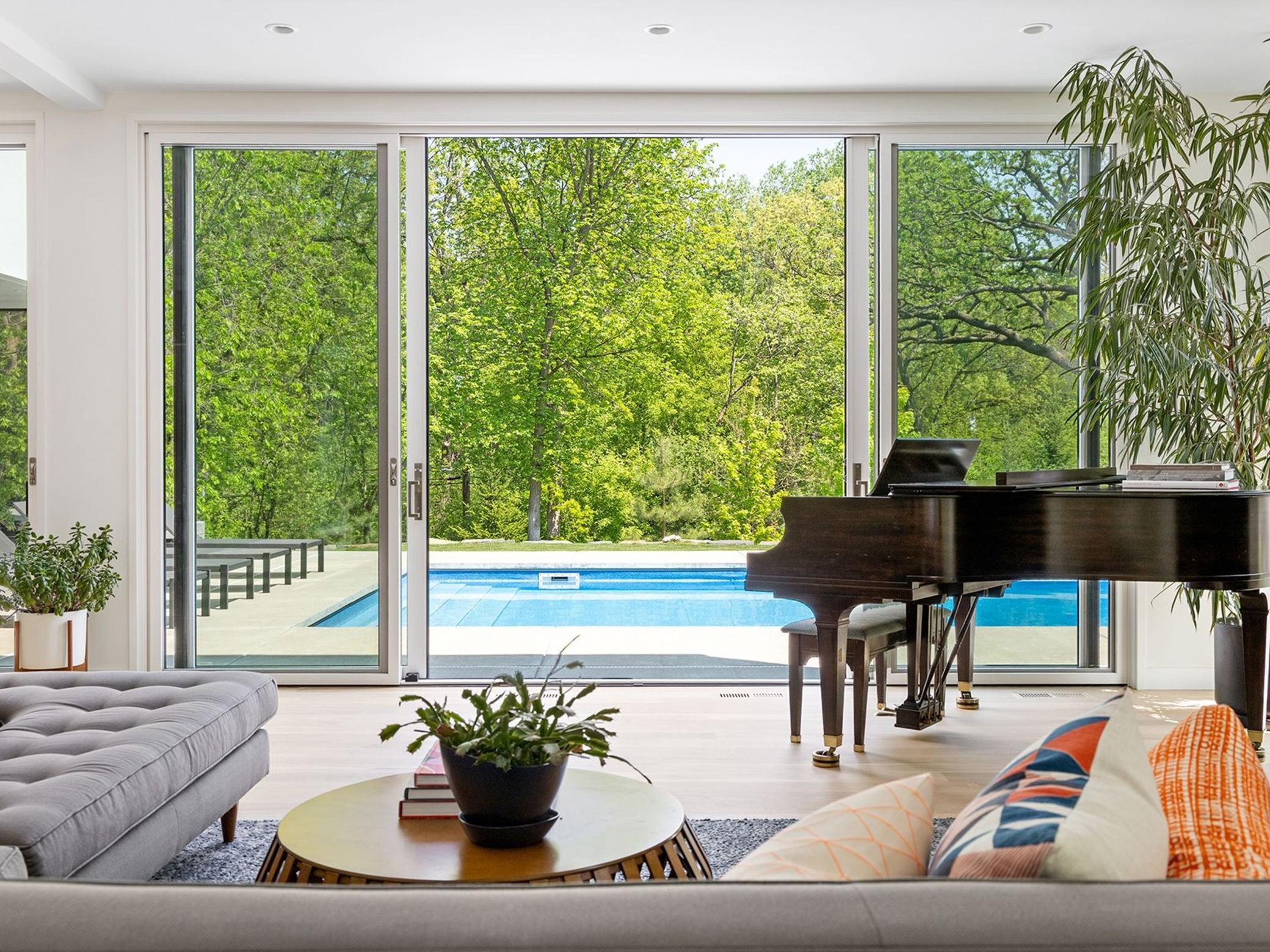 High ceilings, wide plank white oak flooring and expansive sliding glass doors create a light and airy sanctuary.