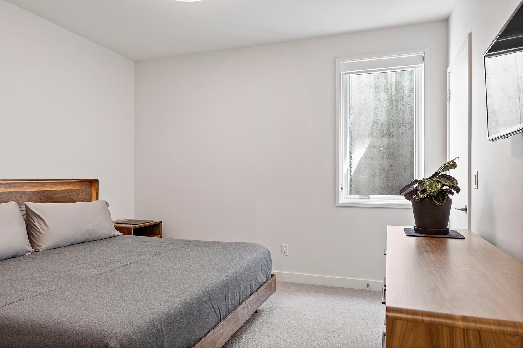 Lower level guest room, complete with an oversized egress window, maximizing the natural light in this space.