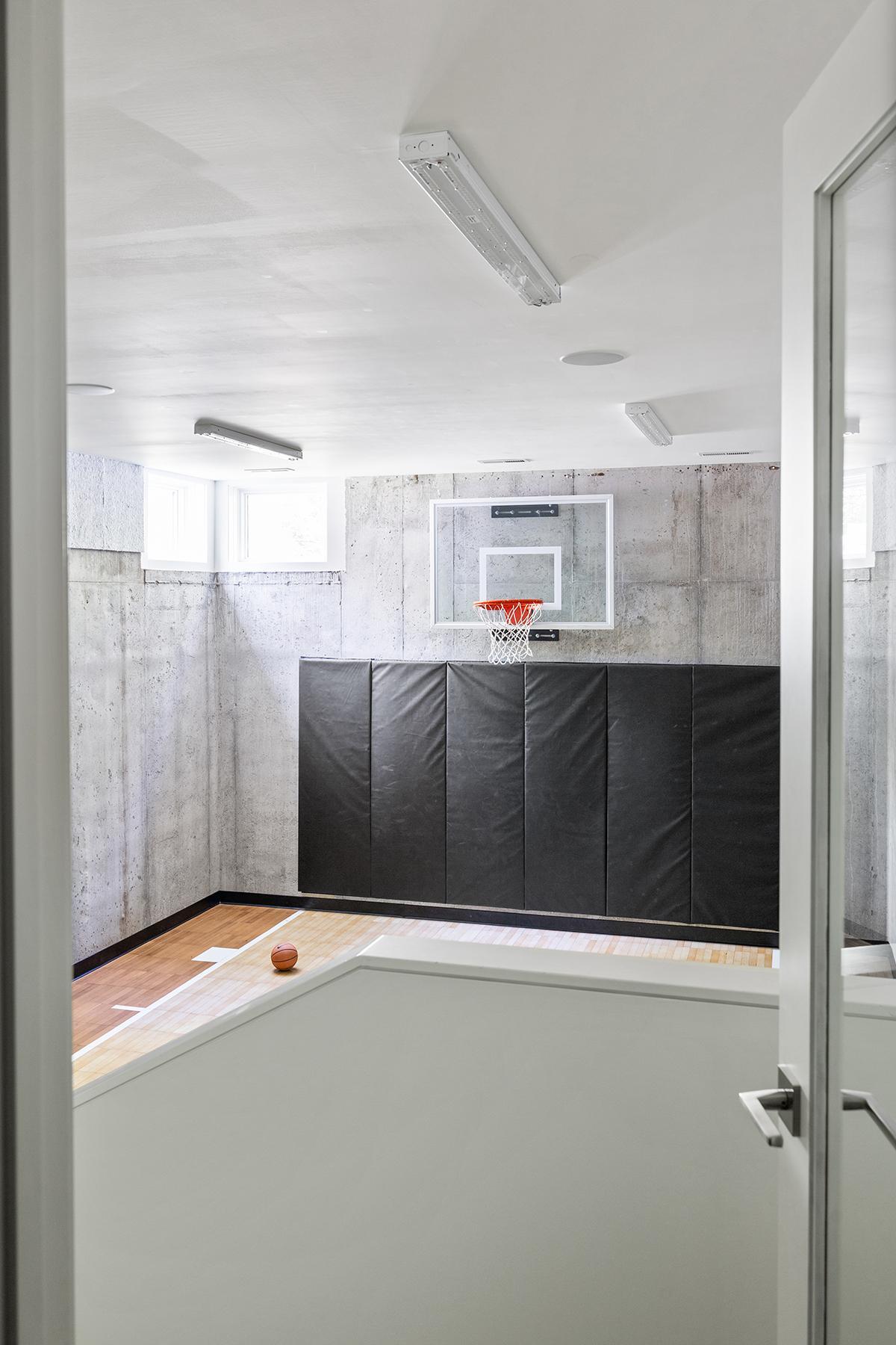 The lower-level sport court echoes the design integrity of the rest of the home.