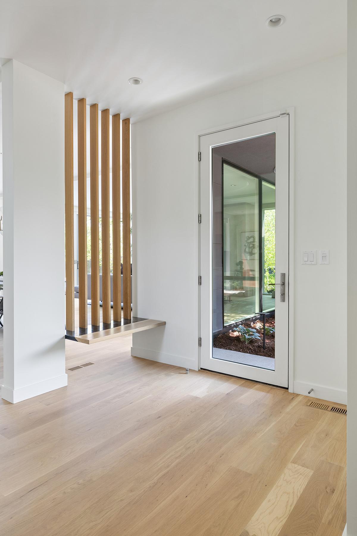 The custom woodwork in the foyer, by Concrete Pig, is functional art.