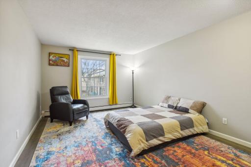 large bedroom with East views, new paint, large window. New high end vinyl plank flooring