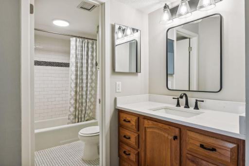 Nice bathroom with newer vanity ,faucet, lighting.
