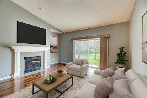 Enjoy cozy nights by the fireplace in the living room. (virtually staged)