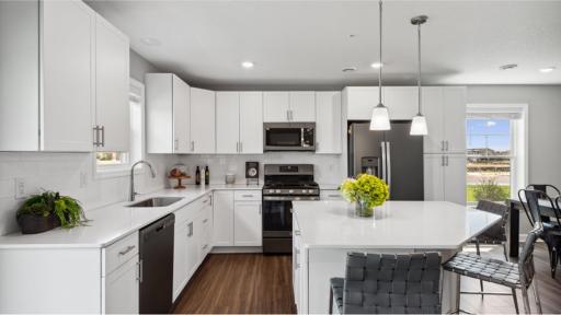 (Photo of a decorated model, actual homes finishes will vary) Welcome to the Jefferson! This kitchen features bar seating for casual meals from morning coffee to midnight snacks.