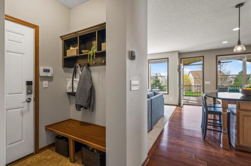 Well-appointed mudroom with built-in bench, providing easy access to the attached 3-car tandem garage for ultimate convenience and functionality.