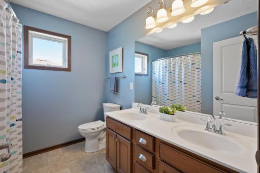 Upper level is complemented by a shared full bathroom featuring a tub/shower combo and dual sinks.