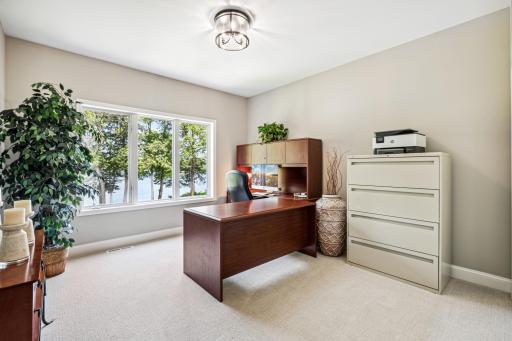 Main floor office, which can also serve as a bedroom, is a versatile space designed for both work and rest, featuring flexible furnishings and convenient access.