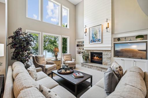 The great room with a vaulted ceiling is a spacious, open-concept area featuring high, sloping ceilings, ample natural light, and a seamless flow between living, dining, and kitchen spaces.