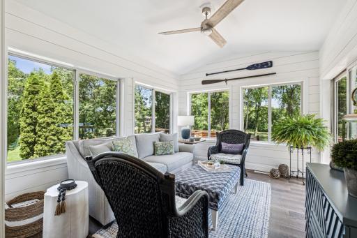 Sunroom with lake views is a bright, airy space featuring expansive windows that offer stunning vistas of the water, creating a serene and relaxing environment.