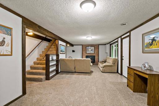 Lower level family room with wood burning fireplace