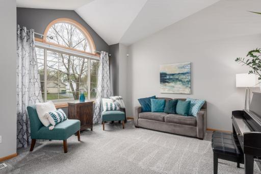 Enjoy tons of natural light in this bright and spacious main level living room with beautiful vaulted ceilings