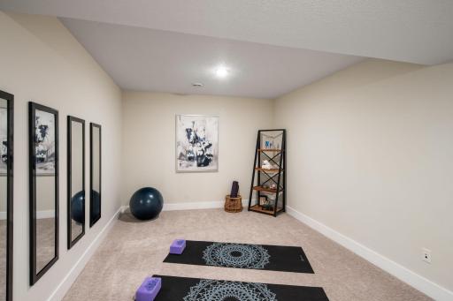 The generous lower level includes flex spaces that can function as an in-home fitness area
