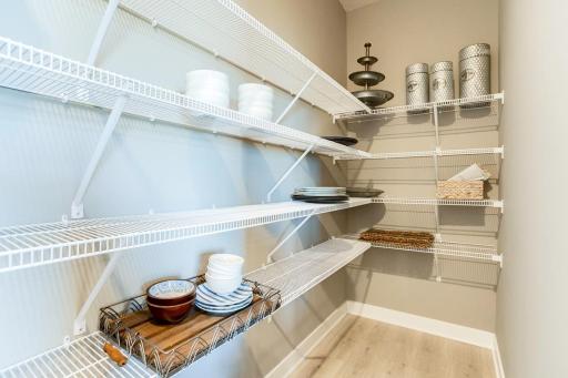 The pantry is situated directly in the kitchen for easy access! *Photo of model home. Selections will differ.
